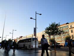 People walking along O'Connell Street on a sunny day